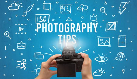 Photo for Hand taking picture with digital camera and PHOTOGRAPHY TIPS inscription, camera settings concept - Royalty Free Image