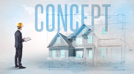 Photo for Young engineer holding blueprint with CONCEPT inscription, house planning concept - Royalty Free Image