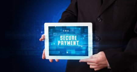 Photo for Young business person working on tablet and shows the digital sign: SECURE PAYMENT - Royalty Free Image