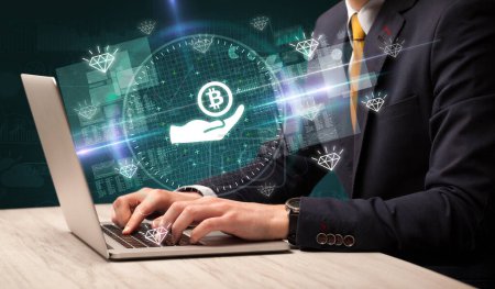 Photo for Business hand working in stock market with giving bitcoin icons coming out from laptop screen - Royalty Free Image