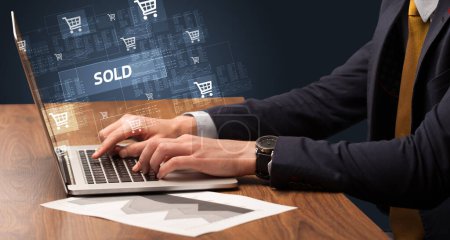 Photo for Businessman working on laptop with SOLD inscription, online shopping concept - Royalty Free Image
