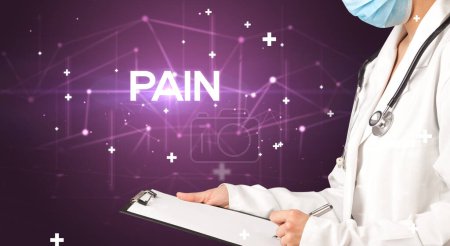 Photo for Doctor fills out medical record with PAIN inscription, medical concept - Royalty Free Image