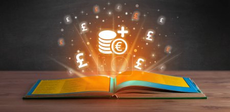 Foto de Libro abierto con iconos de fondos en euros arriba, concepto de cambio de divisas - Imagen libre de derechos
