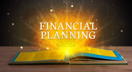 Photo for FINANCIAL PLANNING inscription coming out from an open book, educational concept - Royalty Free Image