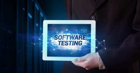 Photo for Young business person working on tablet and shows the inscription: SOFTWARE TESTING - Royalty Free Image
