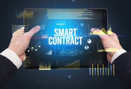 Photo for Close-up of hands holding tablet with SMART CONTRACT inscription, modern business concept - Royalty Free Image