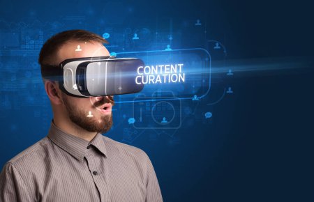 Foto de Hombre de negocios mirando a través de gafas de realidad virtual con inscripción CONTENT CURATION, concepto de redes sociales - Imagen libre de derechos