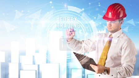Photo for Handsome businessman with helmet drawing FOREX TRADING inscription, contruction business concept - Royalty Free Image
