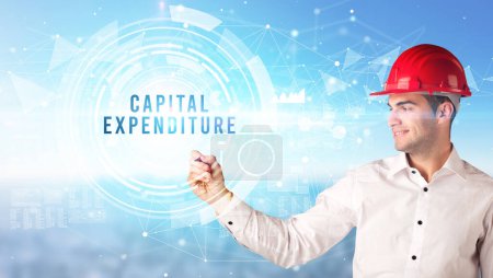 Photo for Handsome businessman with helmet drawing CAPITAL EXPENDITURE inscription, contruction business concept - Royalty Free Image