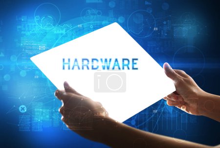 Foto de Tableta futurista Hand Holdig con inscripción HARDWARE, concepto de nueva tecnología - Imagen libre de derechos