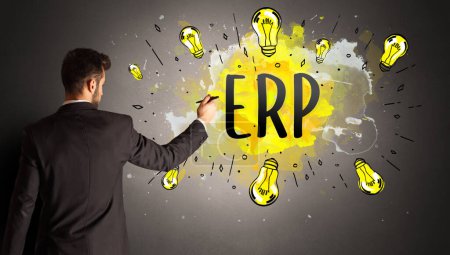 Photo for Businessman drawing colorful light bulb with ERP abbreviation, new technology idea concept - Royalty Free Image
