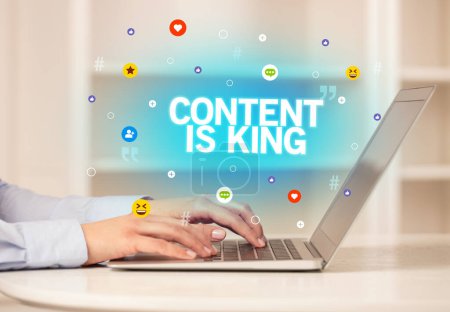 Photo for Freelance woman using laptop with CONTENT IS KING inscription, Social media concept - Royalty Free Image