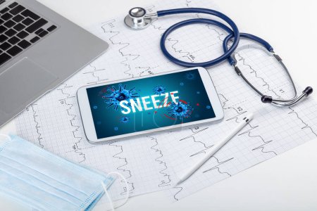Foto de Tablet PC y herramientas médicas en superficie blanca con inscripción SNEEZE, concepto pandémico - Imagen libre de derechos