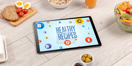 Photo for Healthy Tablet Pc compostion with HEALTHY RECIPES inscription, weight loss concept - Royalty Free Image