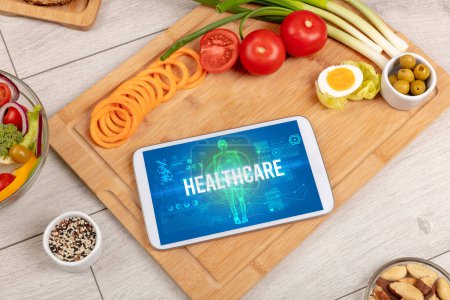 Photo for HEALTHCARE concept in tablet with fruits, top view - Royalty Free Image