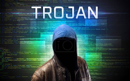 Foto de Pirata informático sin rostro con inscripción TROJAN en un fondo de código binario - Imagen libre de derechos