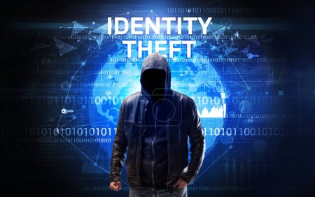 Photo for Faceless hacker at work with IDENTITY THEFT inscription, Computer security concept - Royalty Free Image
