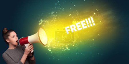 Photo for Young woman yelling to loudspeaker with FREE inscription, modern media concept - Royalty Free Image