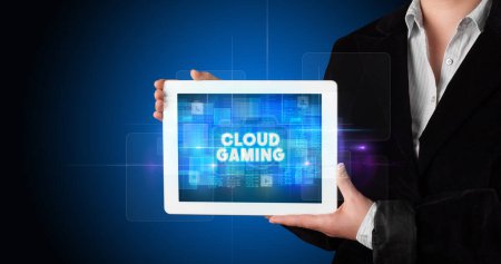 Photo for Young business person working on tablet and shows the inscription: CLOUD GAMING - Royalty Free Image