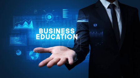 Téléchargez les photos : Main de l'homme d'affaires tenant l'inscription BUSINESS EDUCATION, concept de réussite commerciale - en image libre de droit