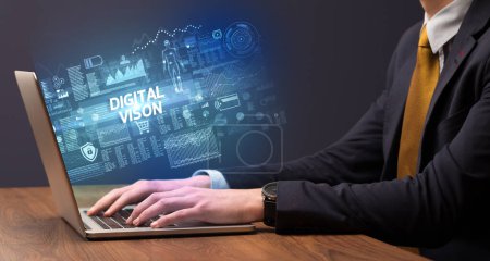 Téléchargez les photos : Homme d'affaires travaillant sur un ordinateur portable avec inscription DIGITAL VISON, concept de cybertechnologie - en image libre de droit