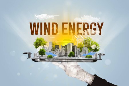 Foto de Camarero sirviendo eco ciudad con inscripción WIND ENERGY, concepto de energía renovable - Imagen libre de derechos
