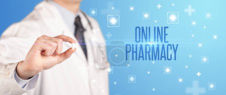 Photo for Close-up of a doctor giving a pill with ONLINE PHARMACY inscription, medical concept - Royalty Free Image