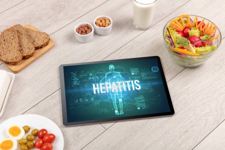 Photo for HEPATITIS concept in tablet with fruits, top view - Royalty Free Image