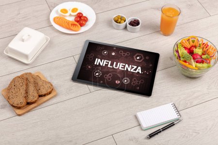 Photo for Healthy Tablet Pc compostion with INFLUENZA inscription, immune system boost concept - Royalty Free Image