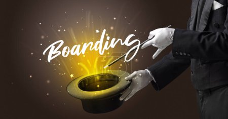 Photo for Magician is showing magic trick with Boarding inscription, traveling concept - Royalty Free Image