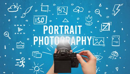 Photo for Hand taking picture with digital camera and PORTRAIT PHOTOGRAPHY inscription, camera settings concept - Royalty Free Image