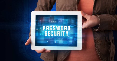 Photo for Young business person working on tablet and shows the digital sign: PASSWORD SECURITY - Royalty Free Image