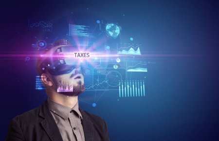 Photo for Businessman looking through Virtual Reality glasses with TAXES inscription, new business concept - Royalty Free Image