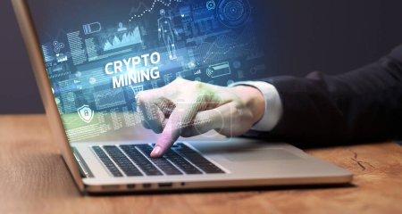 Photo for Businessman working on laptop with CRYPTO MINING inscription, cyber technology concept - Royalty Free Image