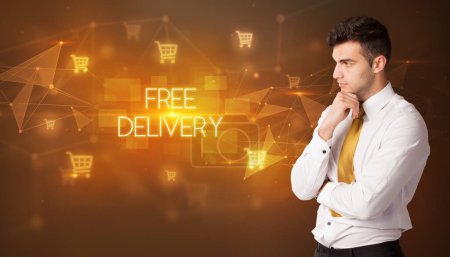 Photo for Businessman with shopping cart icons and FREE DELIVERY inscription, online shopping concept - Royalty Free Image