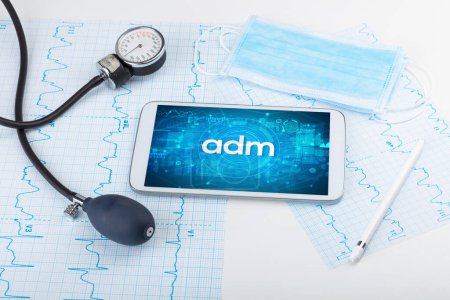 Photo for Close-up view of a tablet pc with adm abbreviation, medical concept - Royalty Free Image