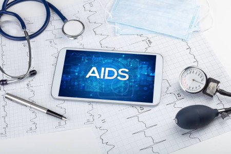 Photo for Close-up view of a tablet pc with AIDS abbreviation, medical concept - Royalty Free Image