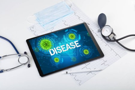 Photo for Close-up view of a tablet pc with DISEASE inscription, microbiology concept - Royalty Free Image
