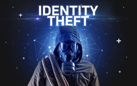 Photo for Mysterious hacker with IDENTITY THEFT inscription, online attack concept inscription, online security concept - Royalty Free Image