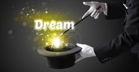Photo for Magician is showing magic trick with Dream inscription, educational concept - Royalty Free Image