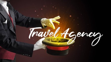 Photo for Magician is showing magic trick with Travel Agency inscription, traveling concept - Royalty Free Image