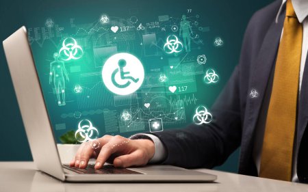 Photo for Hand browsing on the internet for medical issues with handicapped icons coming out from the screen - Royalty Free Image