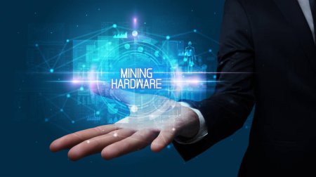 Photo for Man hand holding MINING HARDWARE inscription, technology concept - Royalty Free Image