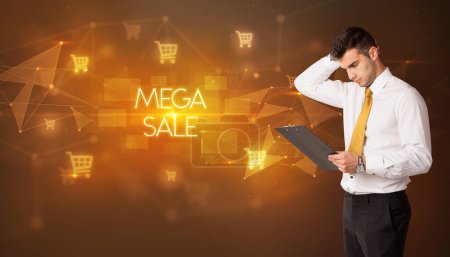 Photo for Businessman with shopping cart icons and MEGA SALE inscription, online shopping concept - Royalty Free Image