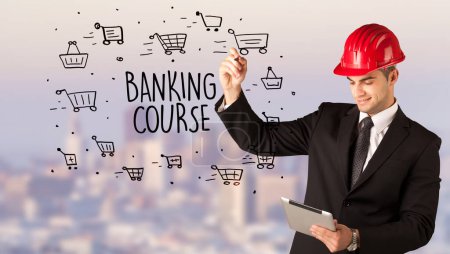 Photo for Handsome businessman with helmet drawing BANKING COURSE inscription, contruction sale concept - Royalty Free Image