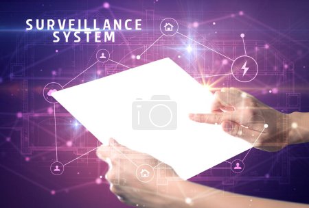 Photo for Holding futuristic tablet with SURVEILLANCE SYSTEM inscription, cyber security concept - Royalty Free Image