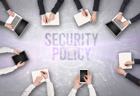 Photo for Group of people in front of a laptop with SECURITY POLICY insciption, web security concept - Royalty Free Image