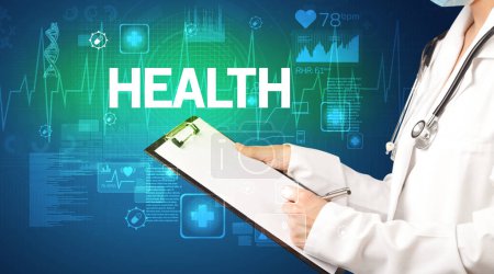Photo for Young doctor writing down notes with HEALTH inscription, healthcare concept - Royalty Free Image
