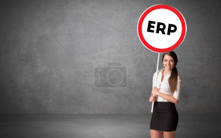 Photo for Young business person holdig traffic sign with ERP abbreviation, technology solution concept - Royalty Free Image