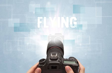 Foto de Primer plano de una cámara digital de mano con inscripción FLYING, concepto de viaje - Imagen libre de derechos